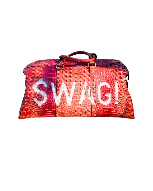 SWAG! Duffle in rust-red croc-embossed vegan leather with white hand-stenciled SWAG! lettering, front view