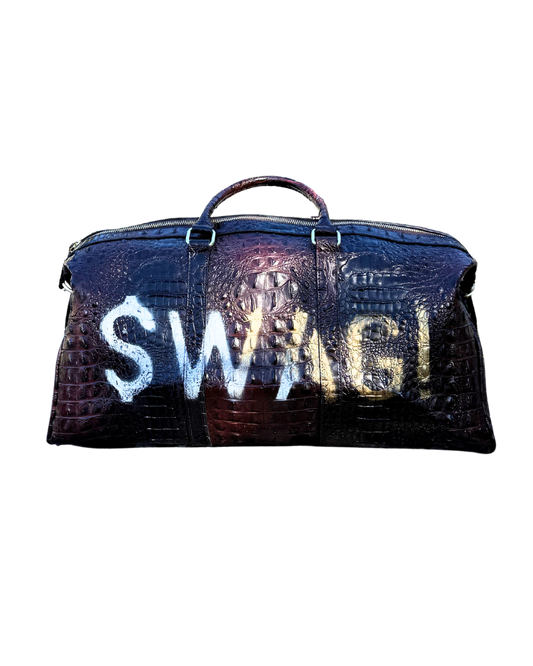 $WAG! Duffle in coffee and navy croc-embossed vegan leather with white hand-stenciled $WAG! lettering, front view